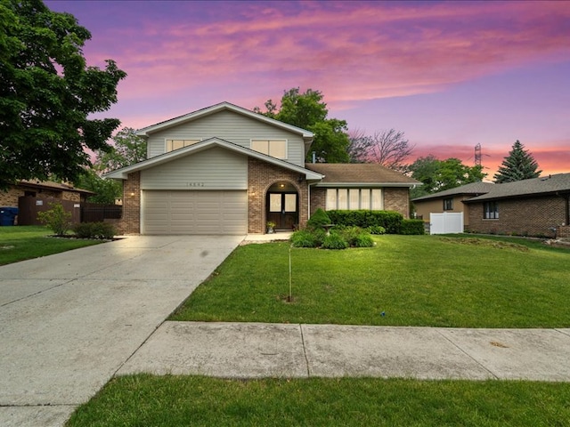 14542 S Mustang Dr, Homer Glen, IL 60491 - view of front facade with brick siding, an attached garage, concrete driveway, and a lawn