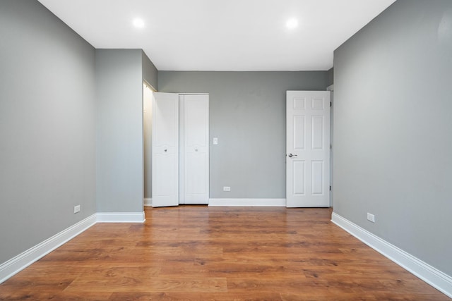 810 N River Rd Unit 3A, Mount Prospect, IL 60056 - unfurnished bedroom featuring baseboards, wood finished floors, recessed lighting, and a closet