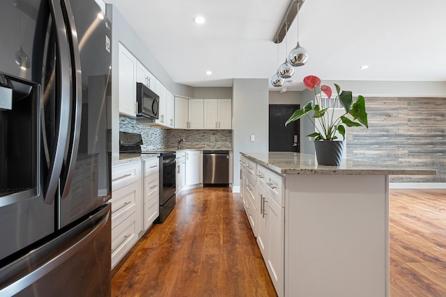 810 N River Rd Unit 3A, Mount Prospect, IL 60056 - kitchen with stainless steel appliances, tasteful backsplash, a kitchen island, wood finished floors, and recessed lighting
