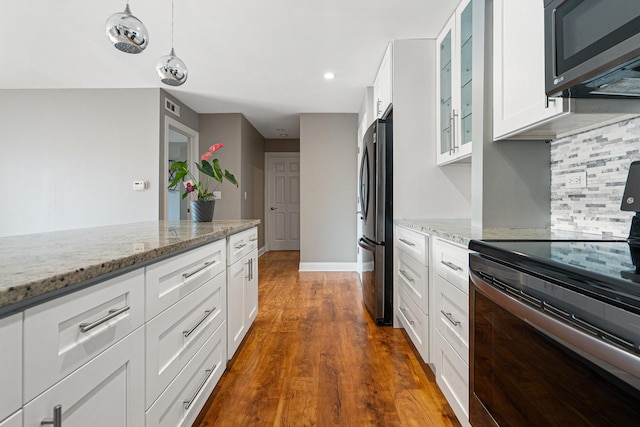 810 N River Rd Unit 3A, Mount Prospect, IL 60056 - kitchen featuring stainless steel appliances, glass insert cabinets, backsplash, light stone countertops, and recessed lighting
