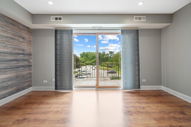 810 N River Rd Unit 3A, Mount Prospect, IL 60056 - empty room featuring wood finished floors, recessed lighting, baseboards, and wooden walls