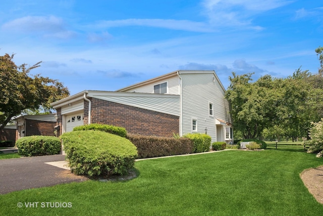 30 W Wimbolton Dr Unit 30, Mount Prospect, IL 60056 - view of side of home with brick siding, an attached garage, a lawn, and driveway
