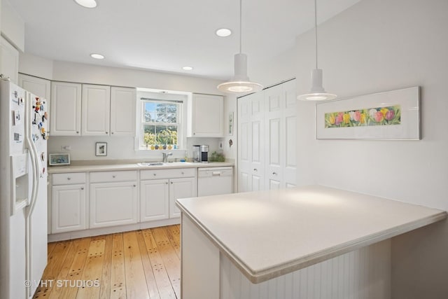 30 W Wimbolton Dr Unit 30, Mount Prospect, IL 60056 - kitchen featuring white appliances, white cabinetry, light countertops, light wood-type flooring, and hanging light fixtures