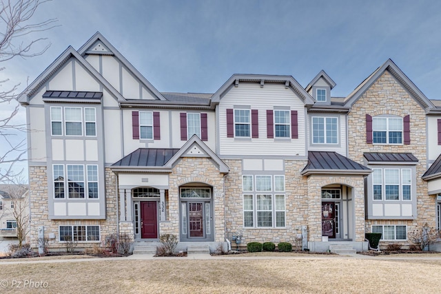 336 Sype Dr, Carol Stream, IL 60188 - view of front facade featuring a standing seam roof, stone siding, metal roof, and a front yard