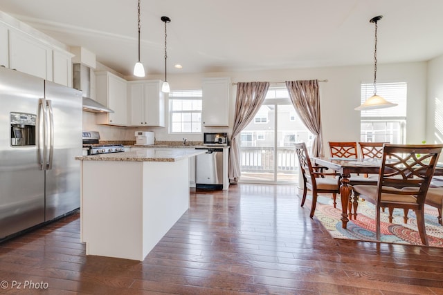 336 Sype Dr, Carol Stream, IL 60188 - kitchen featuring appliances with stainless steel finishes, wall chimney exhaust hood, dark wood finished floors, a kitchen island, and white cabinets