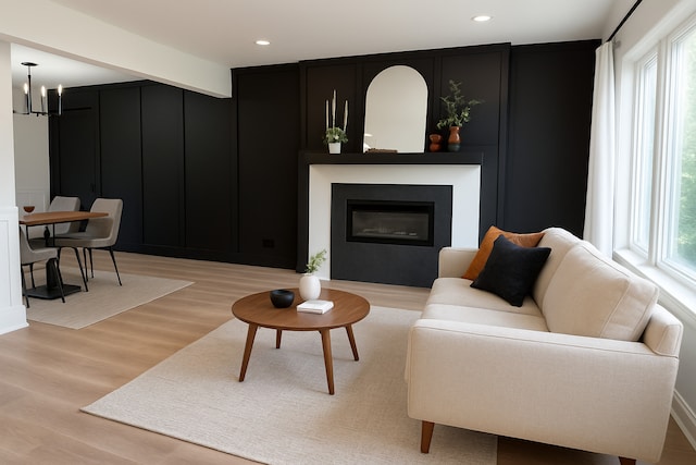 222 S Maple St, Palatine, IL 60067 - living room with a decorative wall, light wood-style floors, a glass covered fireplace, recessed lighting, and a chandelier