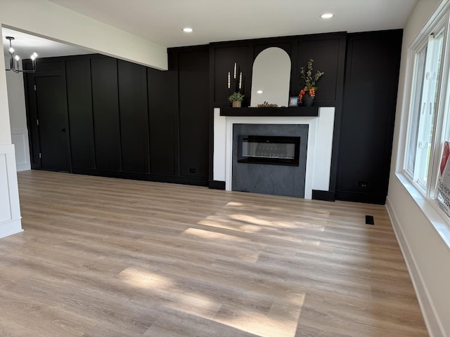 222 S Maple St, Palatine, IL 60067 - unfurnished living room with a decorative wall, a glass covered fireplace, light wood-style floors, a chandelier, and recessed lighting