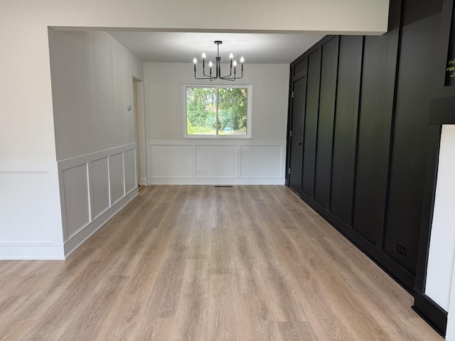 222 S Maple St, Palatine, IL 60067 - unfurnished dining area with a decorative wall, light wood-style flooring, a chandelier, and a wainscoted wall