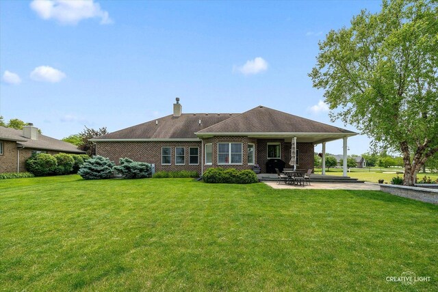 3880 W Nettle Creek Dr, Morris, IL 60450 - rear view of property with a yard, a patio, brick siding, and a chimney