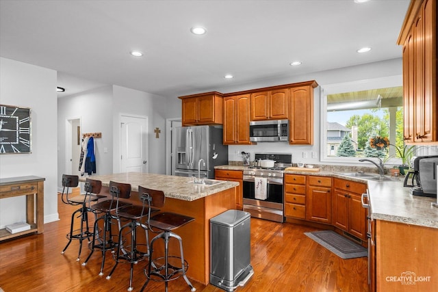 3880 W Nettle Creek Dr, Morris, IL 60450 - kitchen with stainless steel appliances, a sink, wood finished floors, light countertops, and recessed lighting