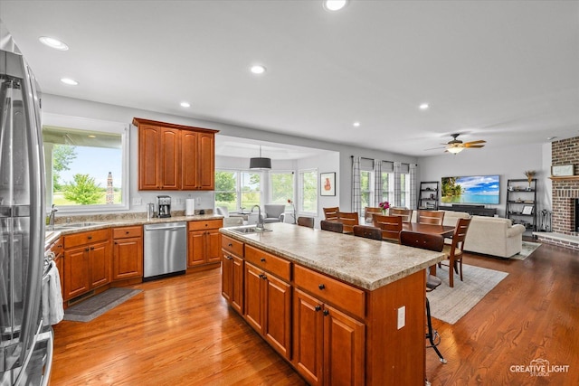 3880 W Nettle Creek Dr, Morris, IL 60450 - kitchen featuring appliances with stainless steel finishes, a sink, light wood-type flooring, light countertops, and ceiling fan