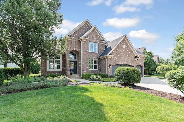 769 Brighton Dr, Sugar Grove, IL 60554 - traditional-style house featuring concrete driveway, brick siding, a front lawn, and an attached garage