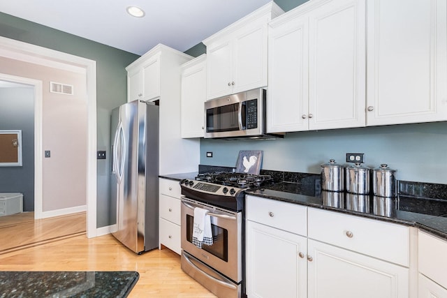 769 Brighton Dr, Sugar Grove, IL 60554 - kitchen with appliances with stainless steel finishes, light wood finished floors, white cabinets, dark stone counters, and recessed lighting
