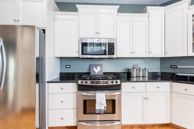 769 Brighton Dr, Sugar Grove, IL 60554 - kitchen featuring appliances with stainless steel finishes, white cabinetry, and dark stone counters