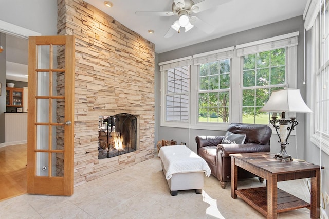 769 Brighton Dr, Sugar Grove, IL 60554 - tiled living area with a ceiling fan, a stone fireplace, and baseboards