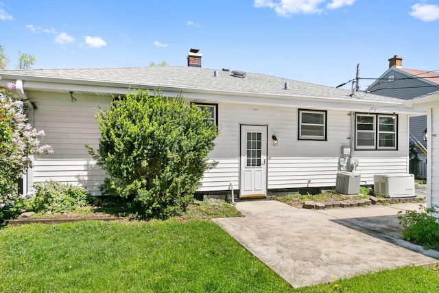 482 Fitch Rd, Chicago Heights, IL 60411 - rear view of property featuring a patio, a chimney, a lawn, central AC, and roof with shingles