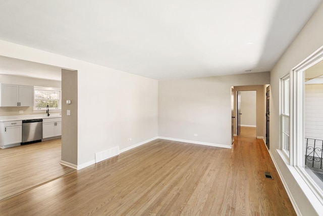 482 Fitch Rd, Chicago Heights, IL 60411 - unfurnished room with light wood finished floors, baseboards, and a sink