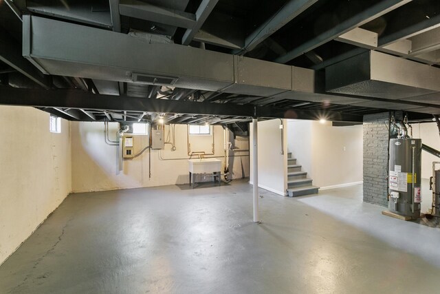 482 Fitch Rd, Chicago Heights, IL 60411 - basement featuring water heater, plenty of natural light, stairs, and a sink