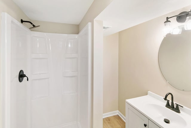 482 Fitch Rd, Chicago Heights, IL 60411 - bathroom with vanity, a shower, baseboards, and wood finished floors
