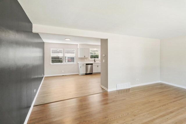 482 Fitch Rd, Chicago Heights, IL 60411 - unfurnished living room with a sink, light wood-style floors, and baseboards