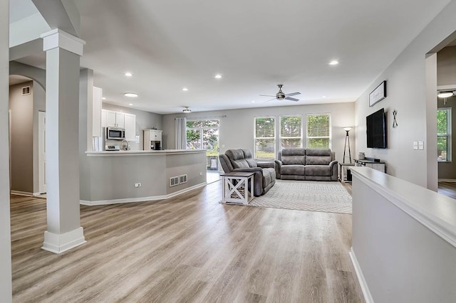 11316 Maplewood Dr, Plainfield, IL 60585 - living area featuring ceiling fan, recessed lighting, light wood-style floors, arched walkways, and decorative columns