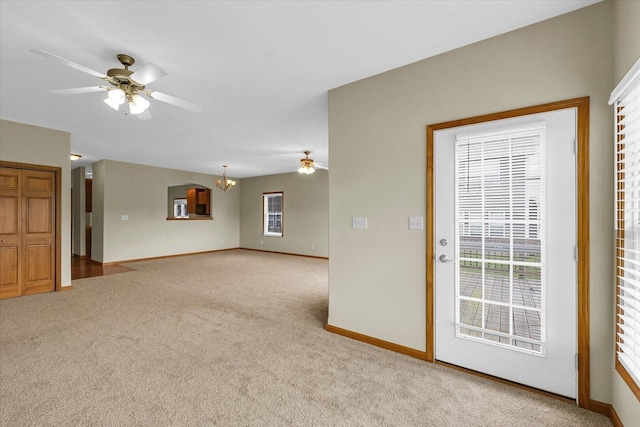 2104A Lucille Ln, Mahomet, IL 61853 - unfurnished living room with a chandelier, a ceiling fan, and carpet flooring
