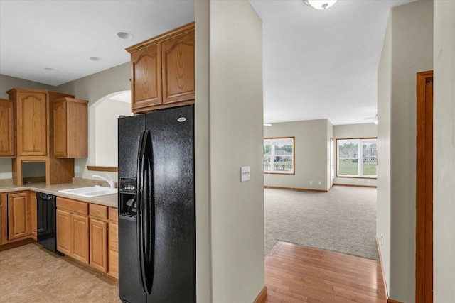 2104A Lucille Ln, Mahomet, IL 61853 - kitchen featuring black appliances, light countertops, arched walkways, and open floor plan