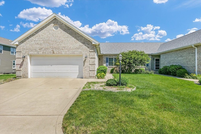 2104A Lucille Ln, Mahomet, IL 61853 - ranch-style house with brick siding, a front lawn, driveway, and a garage