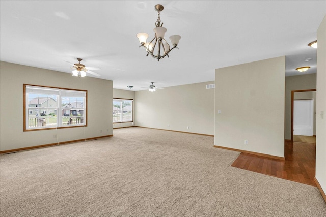 2104A Lucille Ln, Mahomet, IL 61853 - unfurnished living room featuring carpet flooring, a ceiling fan, and a chandelier