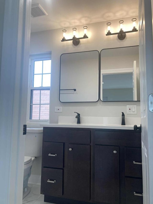 3431 N Kostner Ave, Chicago, IL 60641 - full bath with double vanity, marble look tiles, and toilet