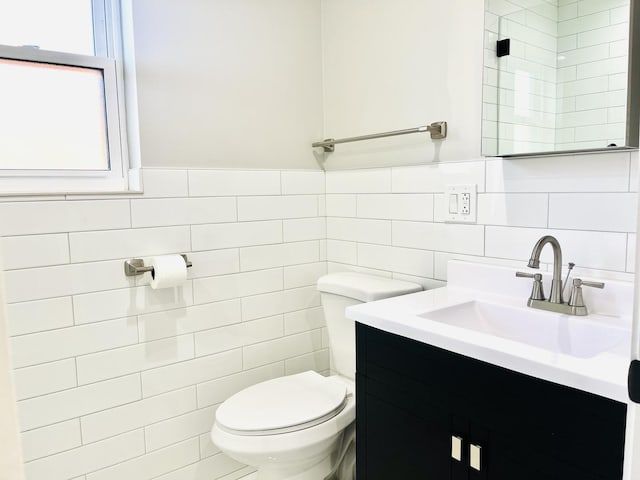 3431 N Kostner Ave, Chicago, IL 60641 - bathroom with tile walls, toilet, vanity, and wainscoting