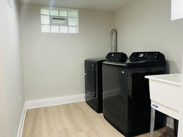 3431 N Kostner Ave, Chicago, IL 60641 - washroom with washer and clothes dryer, light wood-style floors, and baseboards