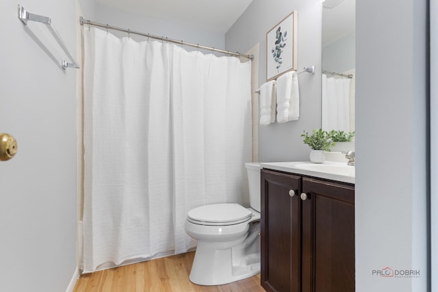 557 E Shag Bark Ln Unit H, Streamwood, IL 60107 - bathroom featuring wood finished floors, vanity, toilet, and shower / bath combo with shower curtain