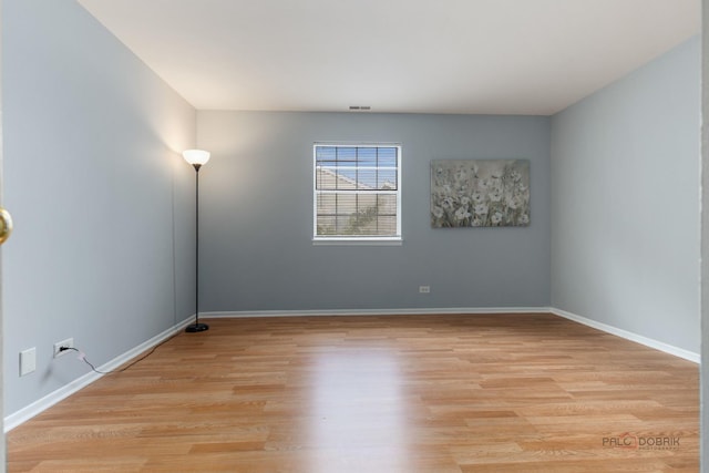 557 E Shag Bark Ln Unit H, Streamwood, IL 60107 - unfurnished room featuring light wood finished floors and baseboards