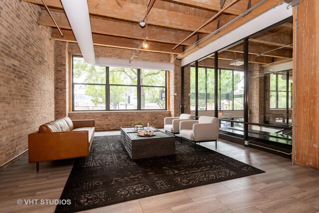1040 W Adams St Unit 365, Chicago, IL 60607 - living area featuring track lighting, brick wall, and healthy amount of natural light