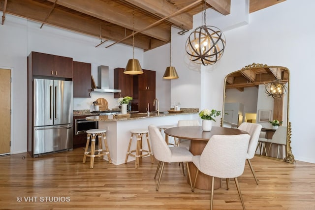 1040 W Adams St Unit 365, Chicago, IL 60607 - dining area with beam ceiling, a high ceiling, light wood-style floors, a chandelier, and arched walkways