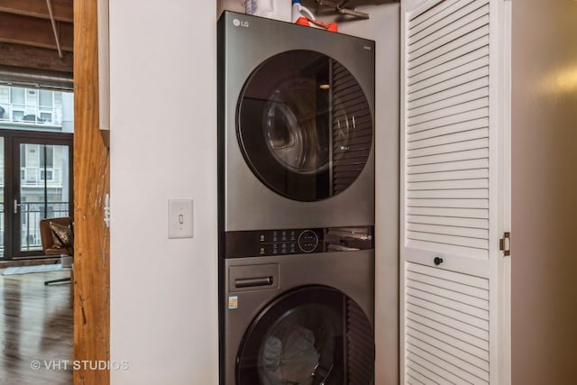 1040 W Adams St Unit 365, Chicago, IL 60607 - washroom featuring stacked washer / dryer and wood finished floors