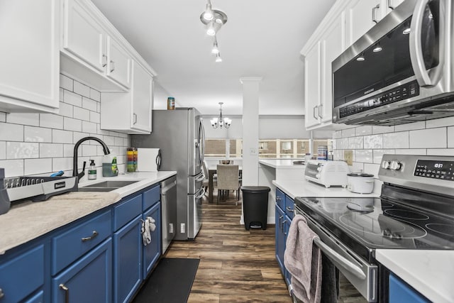 6301 N Sheridan Rd Unit 18E, Chicago, IL 60660 - kitchen with stainless steel appliances, blue cabinets, and a chandelier
