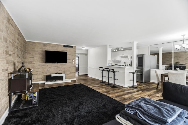 6301 N Sheridan Rd Unit 18E, Chicago, IL 60660 - living room with dark wood-style floors and a chandelier