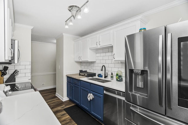 6301 N Sheridan Rd Unit 18E, Chicago, IL 60660 - kitchen featuring stainless steel appliances, blue cabinets, crown molding, white cabinets, and decorative backsplash
