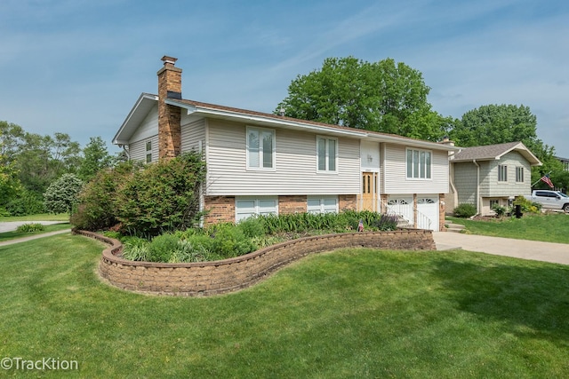 6560 Hillcrest Rd, Downers Grove, IL 60516 - split foyer home featuring a chimney, driveway, a front yard, a garage, and brick siding