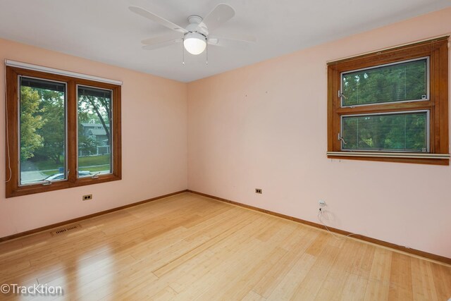 6560 Hillcrest Rd, Downers Grove, IL 60516 - empty room featuring light wood-type flooring, baseboards, and a ceiling fan