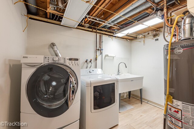 6560 Hillcrest Rd, Downers Grove, IL 60516 - washroom with gas water heater, washing machine and clothes dryer, and light wood-type flooring