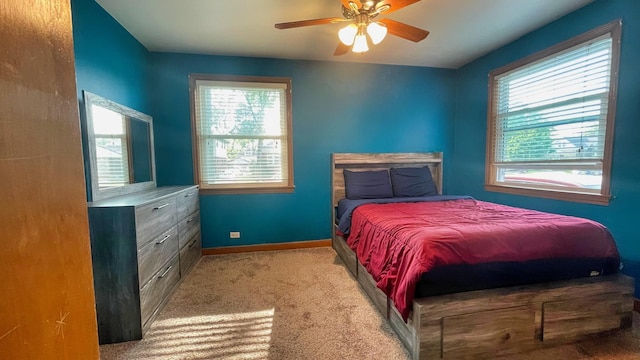 carpeted bedroom with multiple windows and ceiling fan