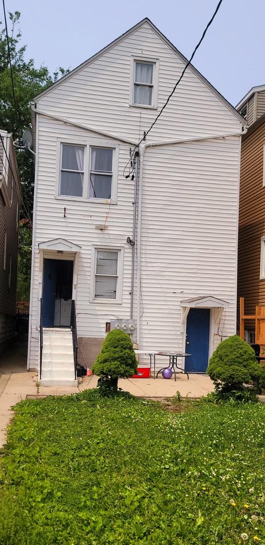 4751 S Hoyne Ave, Chicago, IL 60609 - back of house featuring entry steps, a yard, and a patio