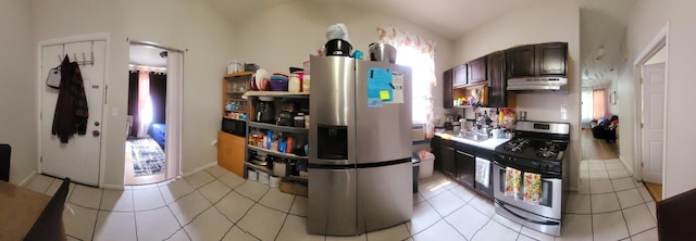 4751 S Hoyne Ave, Chicago, IL 60609 - kitchen with stainless steel appliances, under cabinet range hood, lofted ceiling, light tile patterned flooring, and dark brown cabinets