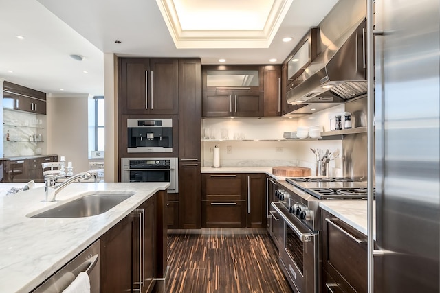 310 S Michigan Ave Unit 1900, Chicago, IL 60604 - kitchen featuring high quality appliances, a sink, wall chimney exhaust hood, dark brown cabinetry, and light stone counters