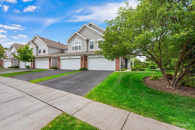 2040 Peach Tree Ln, Algonquin, IL 60102 - view of property featuring an attached garage, driveway, brick siding, and a front lawn