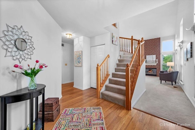 2040 Peach Tree Ln, Algonquin, IL 60102 - staircase featuring a brick fireplace, baseboards, and wood finished floors