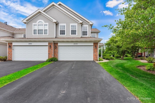 2040 Peach Tree Ln, Algonquin, IL 60102 - view of front facade featuring a garage, a front yard, brick siding, and driveway
